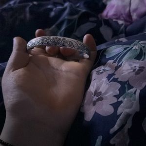 It’s a men and women bracelet adjustable to size silver